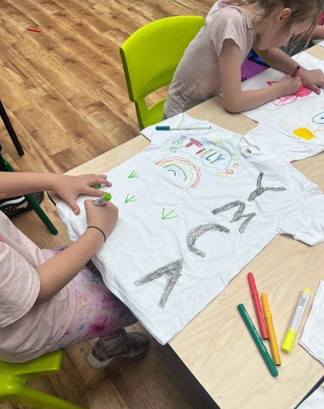 Children designs shirts with YMCA